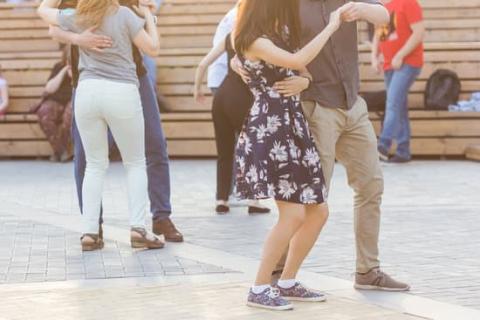 legs, torsos, and arms of several people dancing