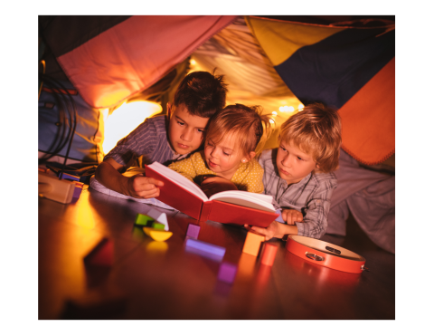 Family of children reading under a blanket fort